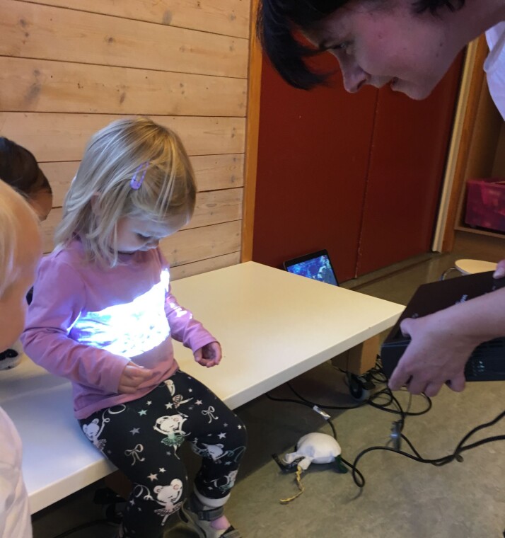 Barnas
fascinasjon var stor da levende bilder ble projisert med små miniprojektorer på toåringens mage. Barnas
fascinasjon var stor da levende bilder ble projisert med små miniprojektorer på toåringens mage.