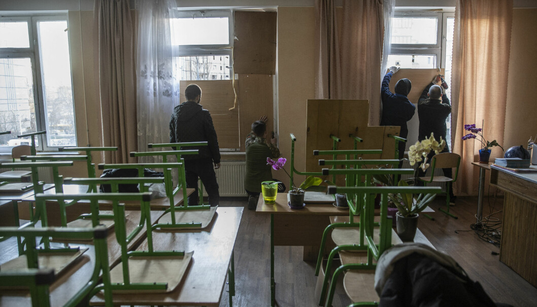 KYIV, UKRAINE - MARCH 20: People board up the windows of a school after it was damaged by Russian shelling in Kyiv, Ukraine on March 20, 2022. Emin Sansar / Anadolu Agency/ABACAPRESS.COM