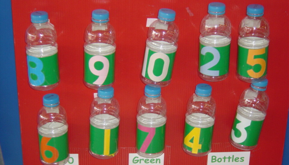Barnehagen har satt frem plastflasker med synlige tall og farger. Barna får leke og sortere tallene i stigende rekkefølge.