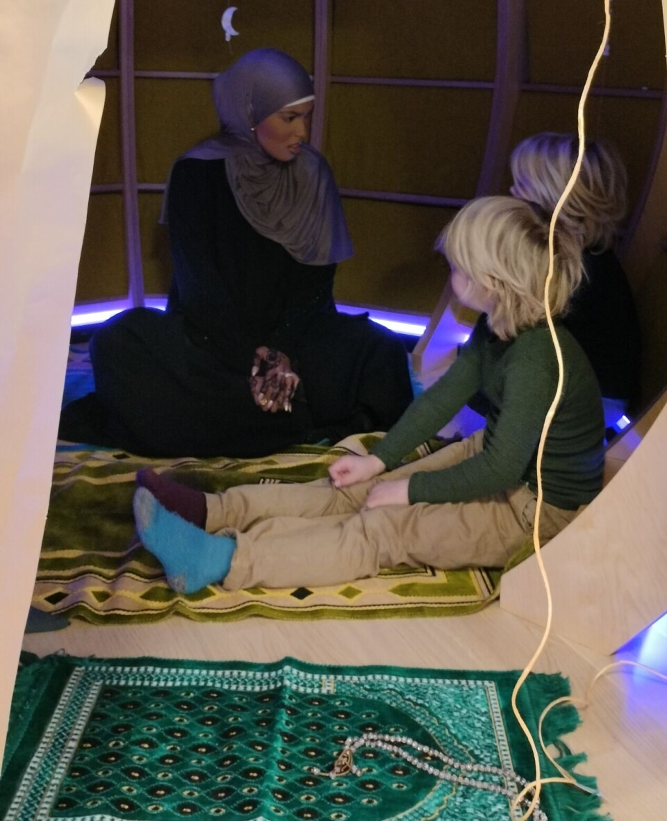 Nasra i samtale med to av barna etter fortellingen i teltet som skulle være Mekka.
