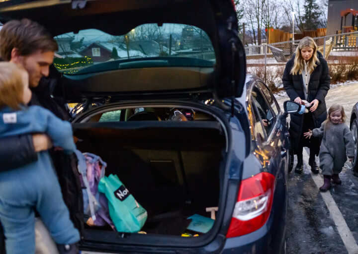 Barn, sekker, klær, poser og foreldre loses inn i bilen.