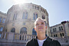 KrF-kandidat Joel Ystebø foran Stortinget med sterk sol og bygningen i bakgrunnen.